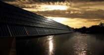 black solar panel near calm body of water