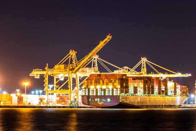 cargo ship on dock during nighttime