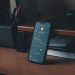 a cell phone sitting on top of a wooden desk