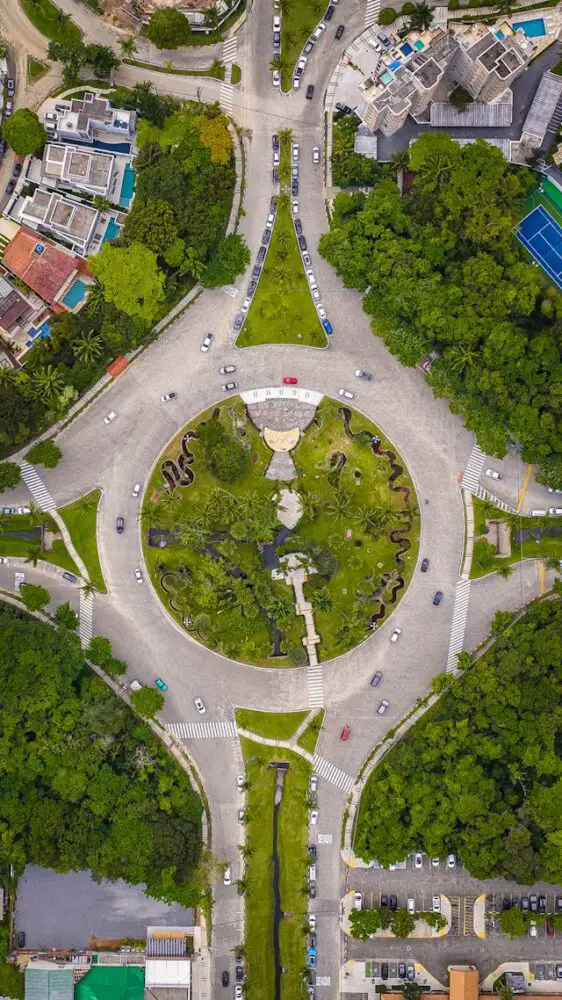 aerial view of scenic traffic roundabout with lush foliage