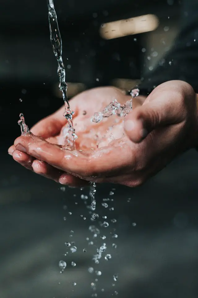 clear liquid pouring on persons hands