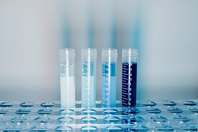 clear plastic test tubes with blue liquid