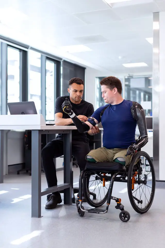 engineer fitting prosthetic arm