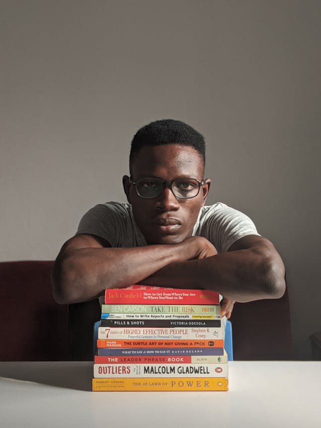 man wearing eyeglasses sitting beside table