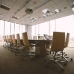 oval brown wooden conference table and chairs inside conference room