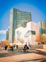 sunny plaza in front of high rise glass buil