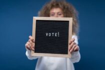 person holding a vote sign